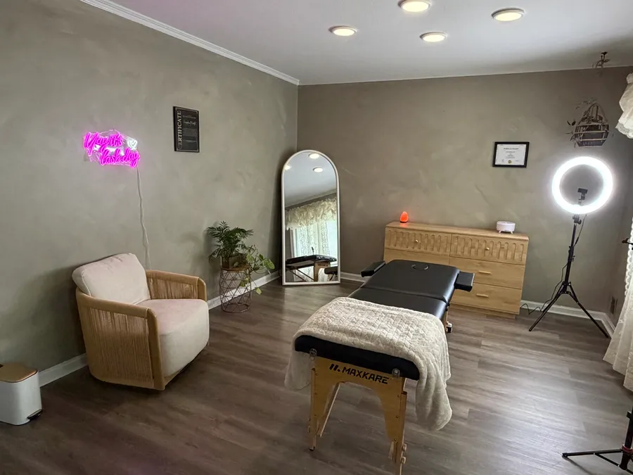 The studio treatment room, with a chair, mirror and treatment table