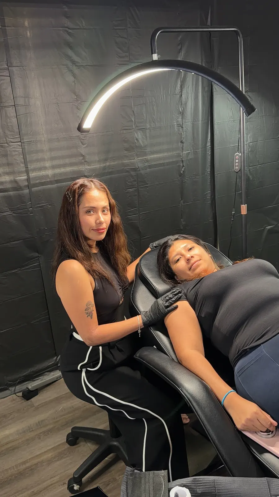 The studio owner with a client in the treatment chair